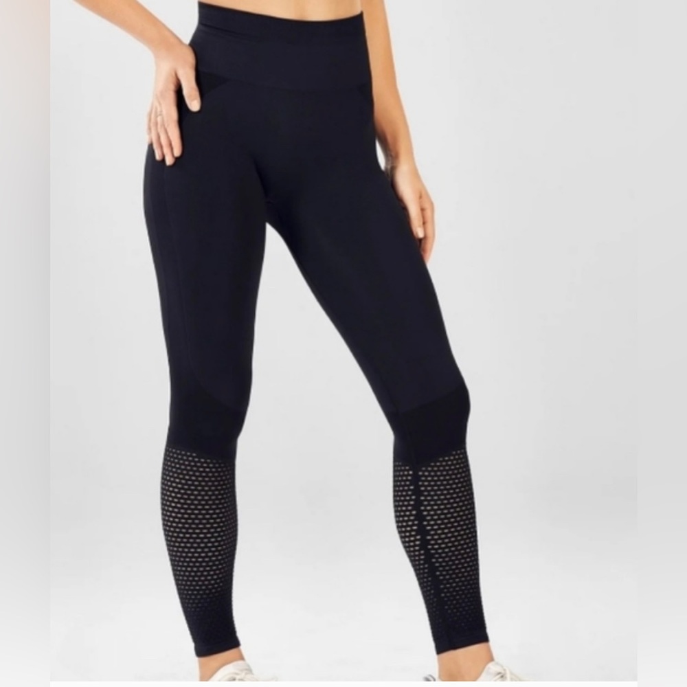 Fabletics powerhold black leggings with mesh ankle detail.